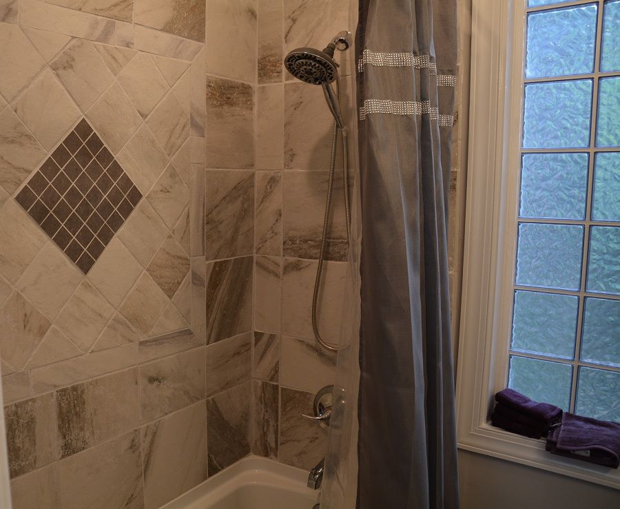<p>Decorative Ceramic Tile in Bathroom with Textured Window</p>